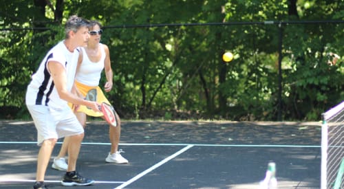 couple playing pickleball at a health club in montrose