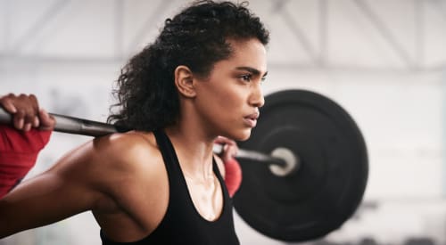 woman in Montrose lifting weights and strength training at premier athletic club