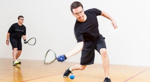 2 male racquetball players compete in a racquetball league at a fitness center near me