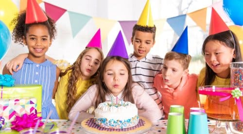 kids celebrate a birthday party wearing colored birthday hats at a children's birthday party venue in montrose