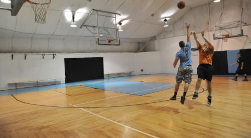 a gym member tries to block another players shot during a basketball game at premier athletic club