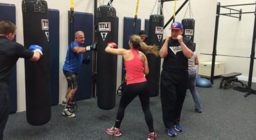 gym members during a small group training class in a functional training area at a montrose athletic club